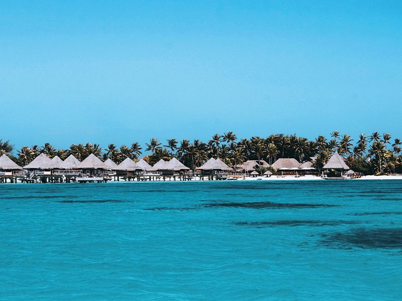 bora bora ocean view with huts along the beach