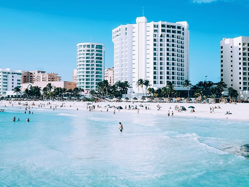 People playing on in the water at a beach in Cancun, Mexico