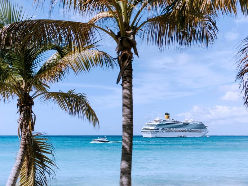 a white ship and a boat sailing on the ocean