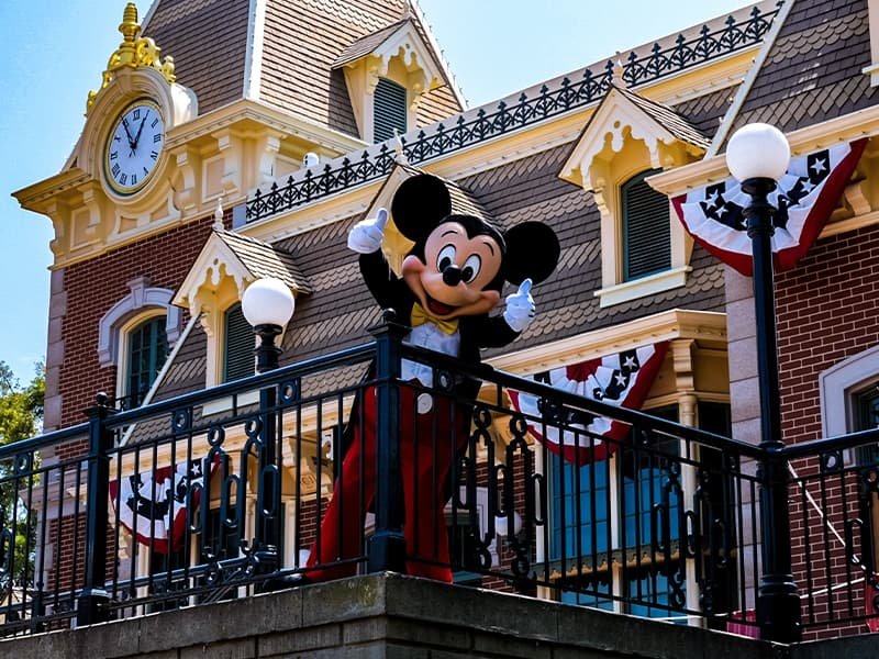Mickey Mouse waving from a balcony