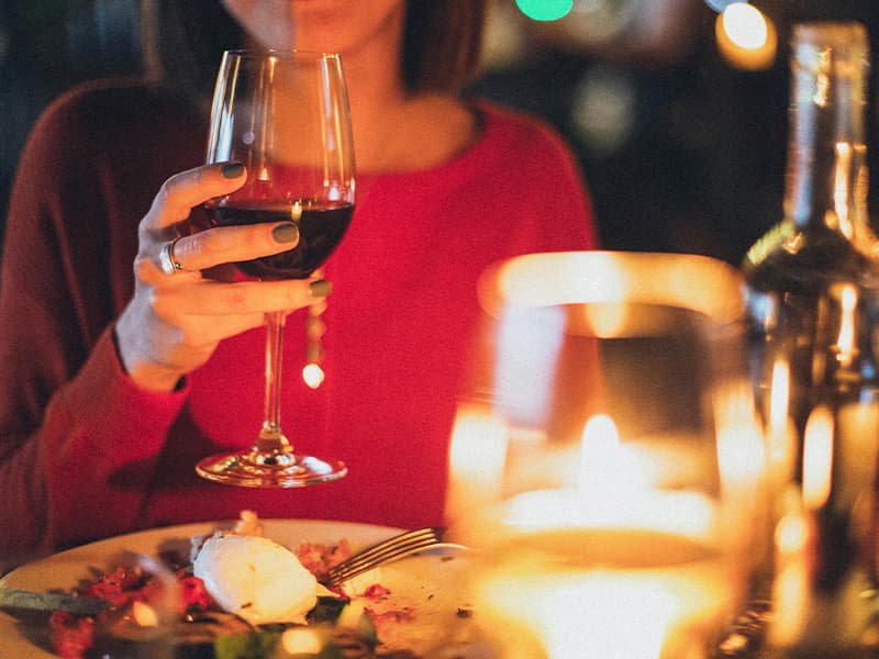 Woman holding a champagne glass at dinner