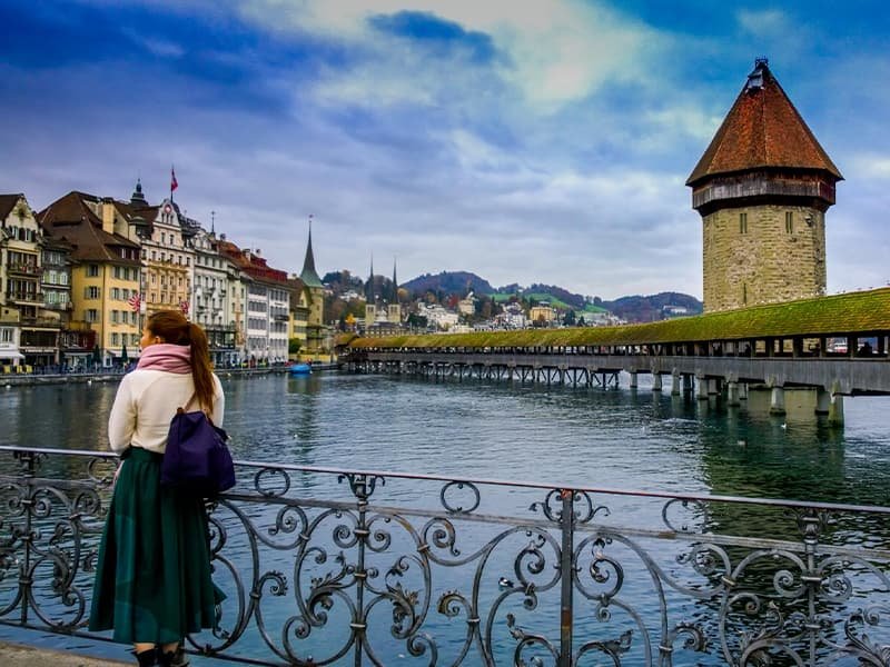 A woman standing in front of an ocean view in Lucerne, Switzerland