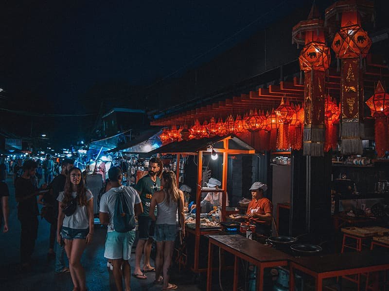 People buying food from a night market in Pai Mai Hong Son, Thailand