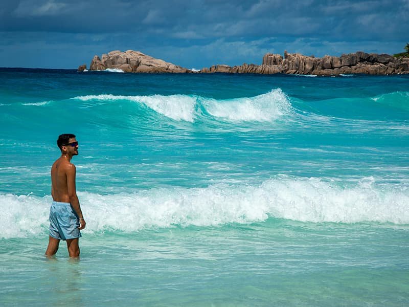 Man on the beach in Seychelles