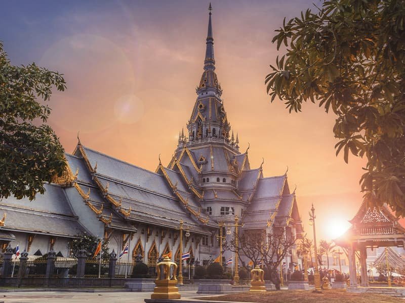 A large ornate building at sunset in Thailand